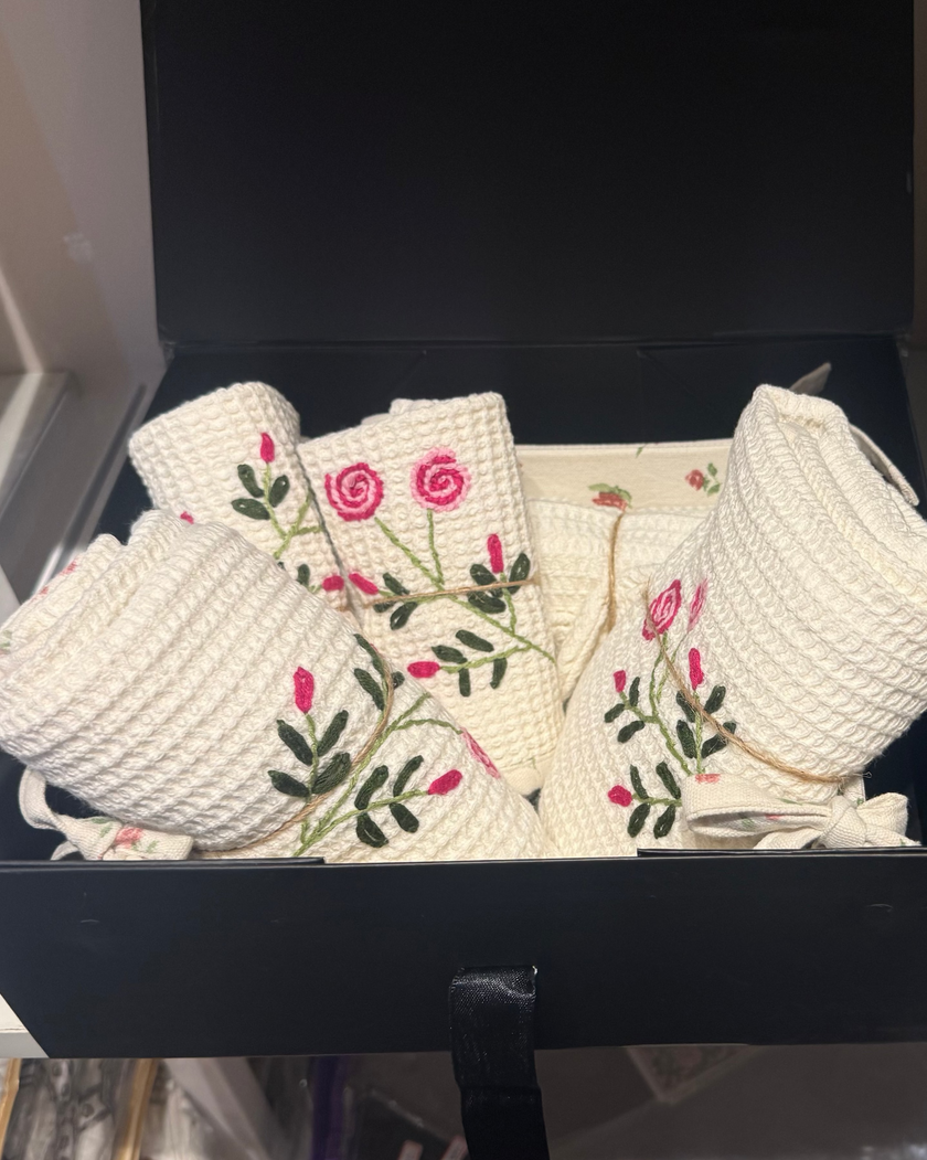 Embroidered fabric pieces in a black box on a white surface