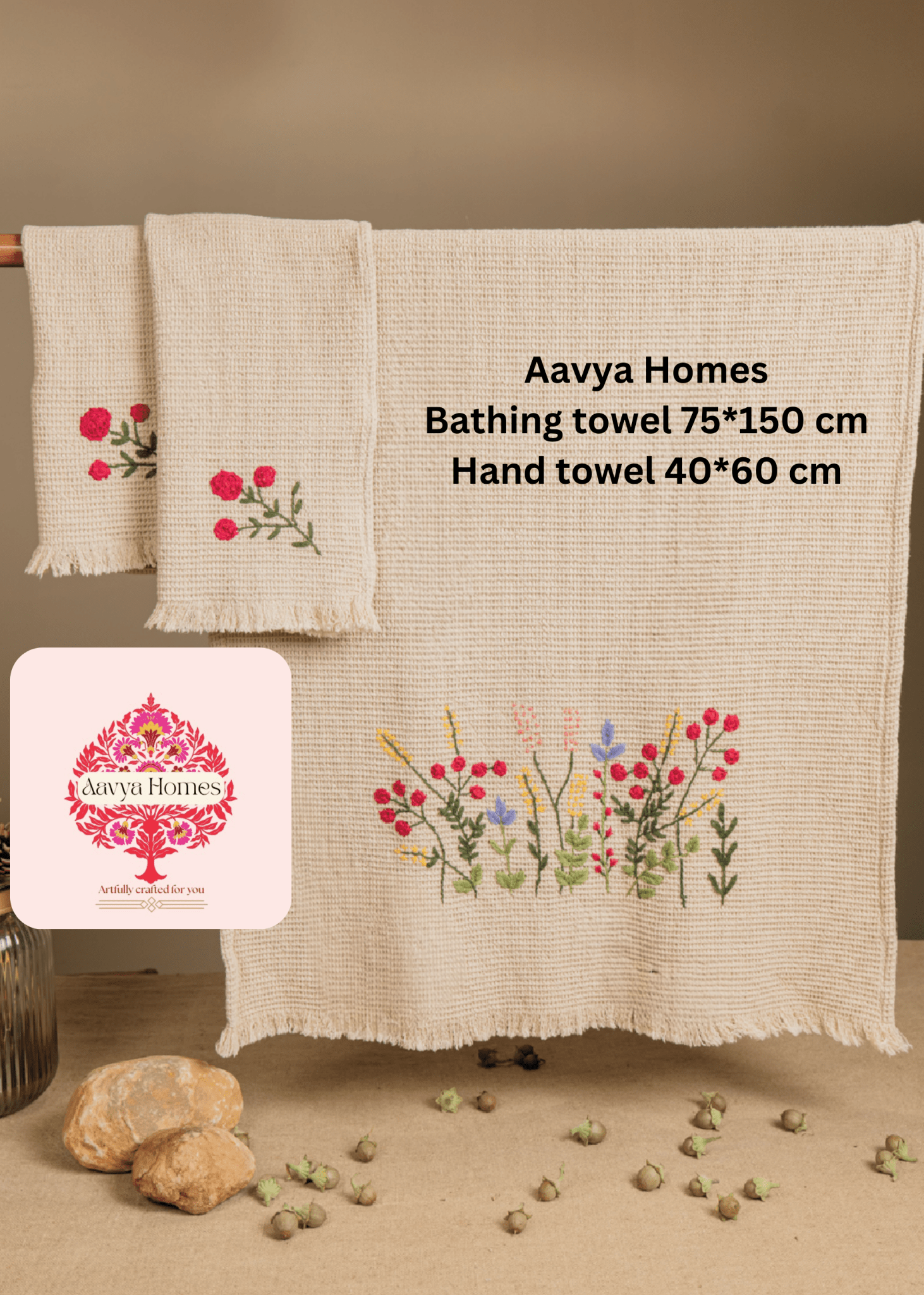 Two Aavya Homes bath towel and hand towel set with floral designs on a wooden rack.