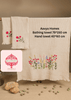 Two Aavya Homes bath towel and hand towel set with floral designs on a wooden rack.