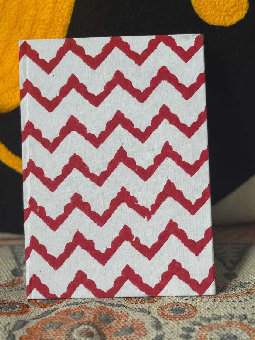 Crimson red geometrical patterns on hand block diary