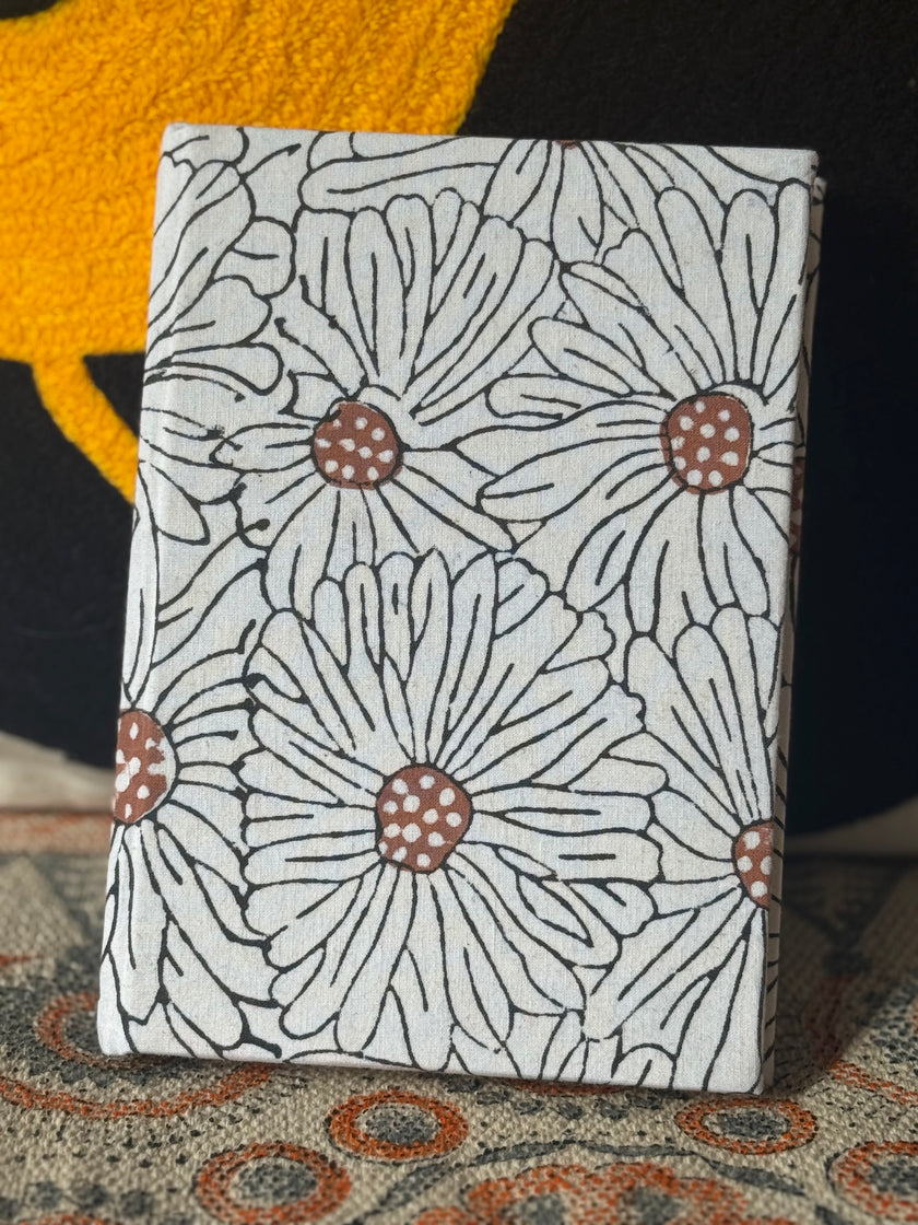 Notebook with floral pattern on a textured surface