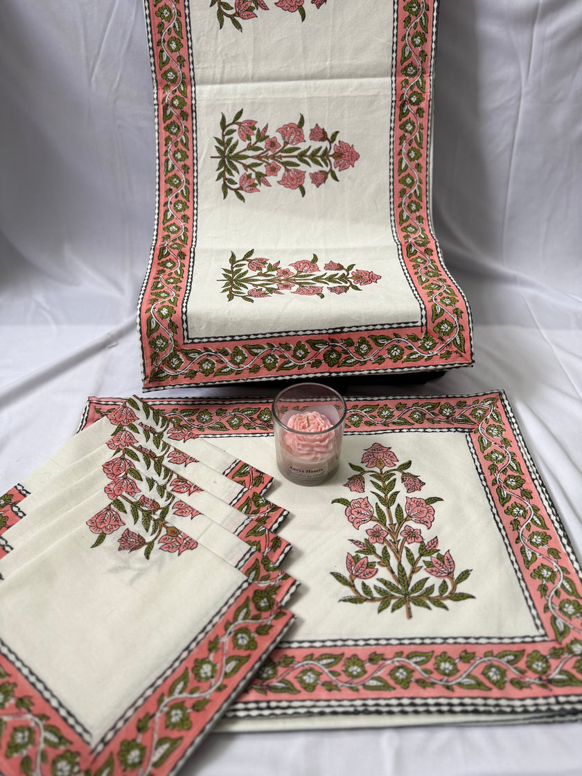 Set of floral embroidered table mats on a white background