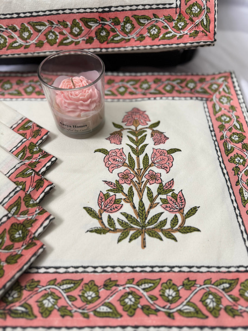 Decorative tablecloth with floral pattern and pink candle on a matching pink border