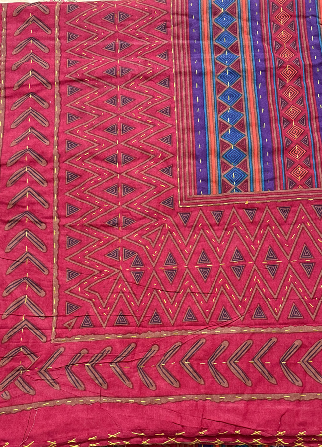 Traditional patterned fabric on a table with decorative edge